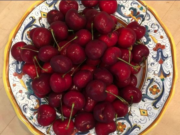 Color aerial image of a bowl of red cherries